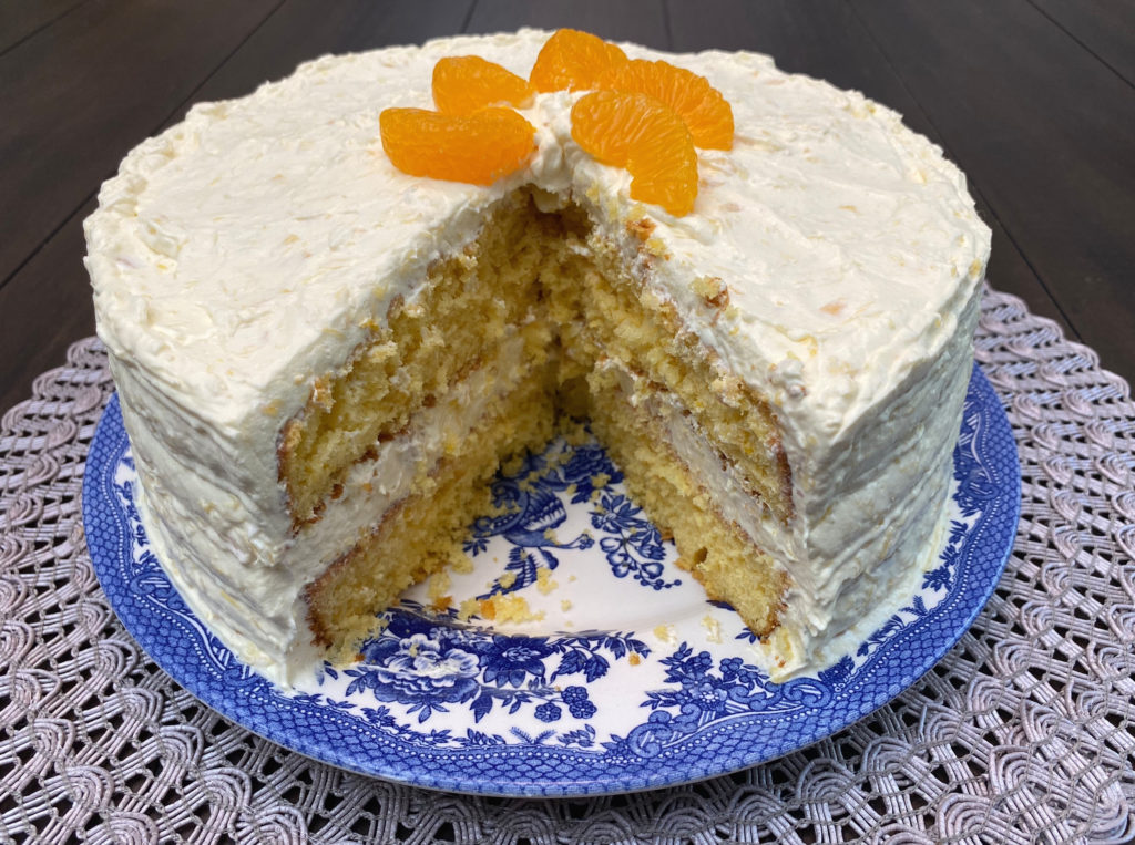 A Pea Picking Cake with a few slices cut out. [pea picking cake]