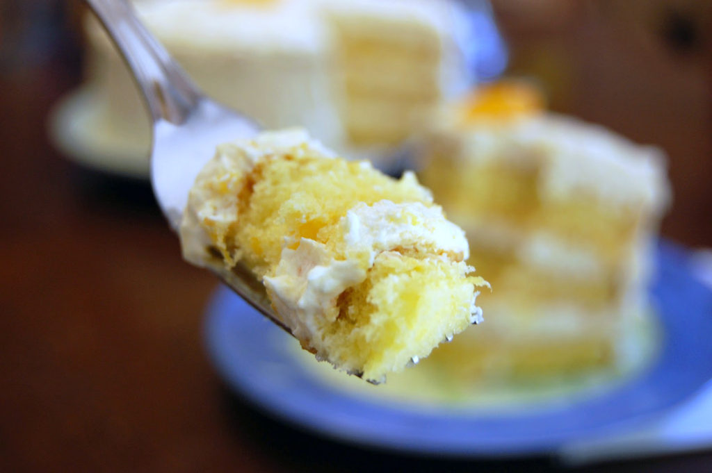 A close-up shot of a bite of cake. [pea picking cake]